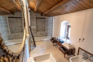 a bathroom with two sinks and a bath tub at Feudo Nobile in Gela +52 photos