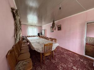 a dining room with a long table and chairs at Karkyra in Dzhergalan