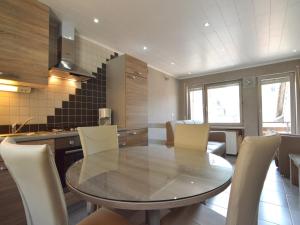 a kitchen with a table and chairs in a room at Attractive Apartment in Zell near River in Zell an der Mosel