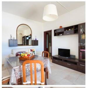 a living room with a table with a bowl of fruit on it at Casa vacanze La Campanella in Putignano
