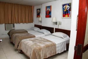 Postel nebo postele na pokoji v ubytování Hotel California Panama + 35 fotografií