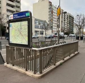 a bus stop sign with a map on a city street at Le nid doux - proche Paris & métro in Villejuif