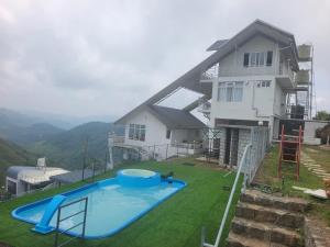 a house with a swimming pool in the yard at Castra villas - Pool Villa in Parunthumpara in Vandiperiyār