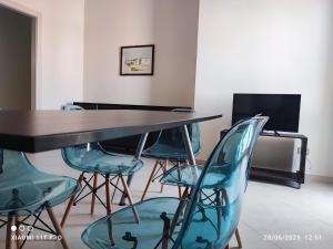 a dining room with a table and four chairs at Villette di Torre Inserraglio in Nardò