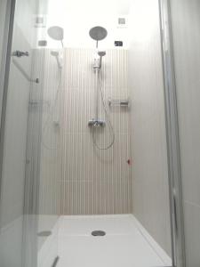 a bathroom with a shower with a glass door at Areté Luxury Room in Reggio di Calabria