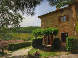 an old stone house with a view of the countryside at Farmhouse with stables, horses and the ability to make horseback riding in Monte Santa Maria Tiberina