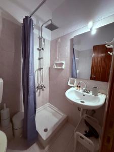 a bathroom with a sink and a shower and a toilet at Argiro's apartment at Agia Galini in Agia Galini