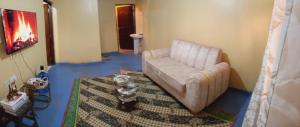 a living room with a couch and a rug at BIGO Apartment in Marsabit