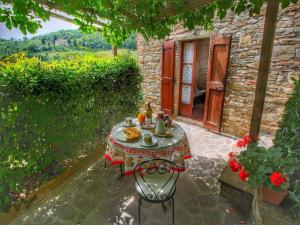 a table with food on it next to a building at Farmhouse with stables, horses and the ability to make horseback riding in Monte Santa Maria Tiberina