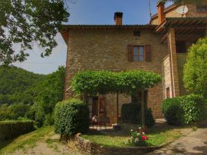 an old stone house with a table in front of it at Farmhouse with stables, horses and the ability to make horseback riding in Monte Santa Maria Tiberina