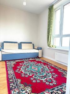 a bedroom with a bed and a red rug at Cozy year-round cottage near UB with additional pick-up service from the Airport in Dzuunmod