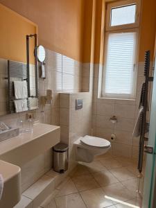 a bathroom with a toilet and a sink at Hotel Union Salzwedel in Salzwedel