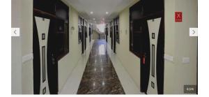 a corridor of a hallway with doors and a long aisle at Hotel O Alpine in Chandīgarh