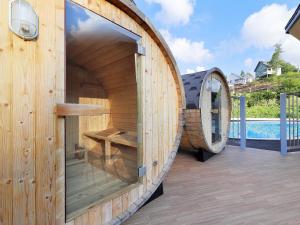 a wooden play house with a large window next to a pool at Resort Villa Takayama in Takayama +34 photos