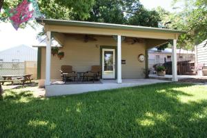 a pavilion with a table and chairs on a patio at Agape Cottage in Fredericksburg