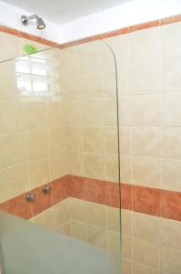 a shower with a glass door in a bathroom at Complejo Las Hoyas in Villa Carlos Paz