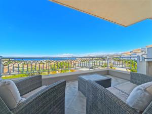a balcony with chairs and a view of the ocean at La Parenthèse Corse in LʼÎle-Rousse