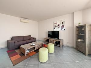 a living room with a couch and a coffee table at La Parenthèse Corse in LʼÎle-Rousse