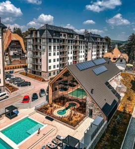 an aerial view of a hotel with a swimming pool at Titova Vila - Golden Peak Residence in Zlatibor
