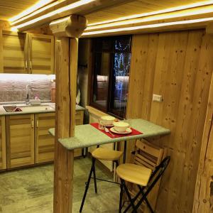 a kitchen with a counter with chairs and a table at Le joli nid in Les Deux Alpes +36 photos