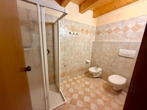 a bathroom with a shower and a toilet and a sink at B&B La Montanara in San Martino di Castrozza +91 photos