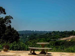 a stone bench sitting on top of a hill at Satoris in Kloof