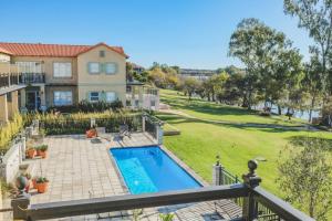 a house with a swimming pool and a yard at Pont de Val Boutique Hotel And Apartments in Barrage