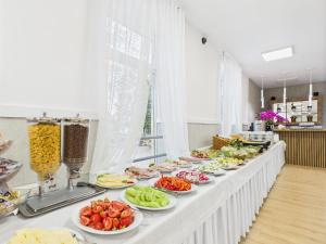 a buffet line with plates of food on it at Hotel Miramar in Sopot +59 photos