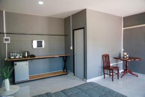 a room with a bed and a desk and a table at Npuhomestay Naka Cave in Bung Khong Long