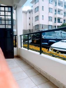 a balcony with a car outside of a building at MBABAZI VILLa in Syokimau +1 photo