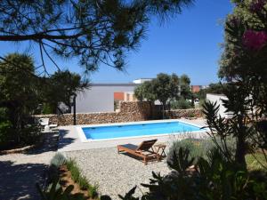 a swimming pool with a lounge chair next to it at Quaint holiday home in Mandre with private garden in Mandre +80 photos