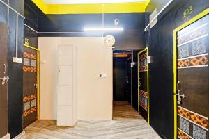 a hallway with a clock on the wall at Hotel O Mo Kudia in Brahmapur