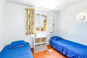 a bedroom with two blue beds and a window at Villa Alto by Villa Plus in Spéracèdes +27 photos