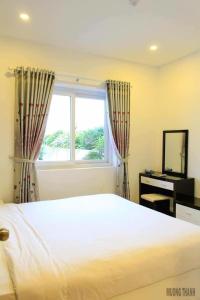 a bedroom with a large bed and a window at Nha Trang Seaview Penthouse Apartment in Nha Trang +38 photos