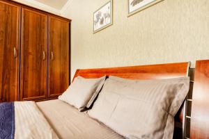 Arbat 2 апартаменты в центре города - выбор для туриста и деловых поездок في ألماتي: غرفة نوم مع سرير مع اللوح الأمامي الخشبي +16 صورة