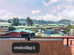 a sign on a ledge overlooking a city at Unit 302, 3rd Floor in Baguio