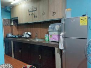 a kitchen with a sink and a refrigerator at Unit 302, 3rd Floor in Baguio