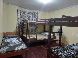 a room with three bunk beds in it at Unit 302, 3rd Floor in Baguio +5 photos