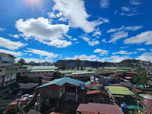 a city with buildings and a blue sky with clouds at Unit 302, 3rd Floor in Baguio