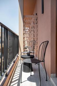 two chairs and a table on a balcony at Zoera Suites by Ethos in Chania Town