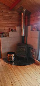 a woodburning stove in a room in a cabin at Fredbo in Melåa