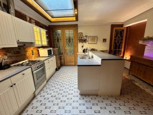 a large kitchen with white cabinets and a window at Maison 1873 in Antwerp