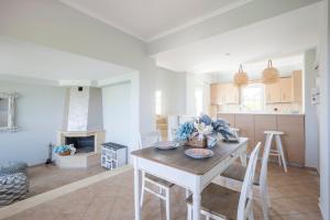 a kitchen and living room with a table and chairs at Afitos deluxe home in Afitos