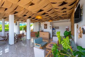 a living room with a wooden ceiling at Hotel Kata Hill Sea View in Kata Beach