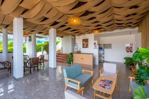 a living room with a wooden ceiling at Hotel Kata Hill Sea View in Kata Beach