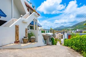 a street in a town with white buildings at Hotel Kata Hill Sea View in Kata Beach