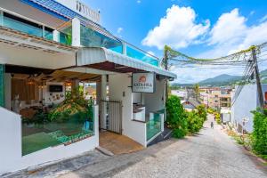a street view of a building with a restaurant at Hotel Kata Hill Sea View in Kata Beach