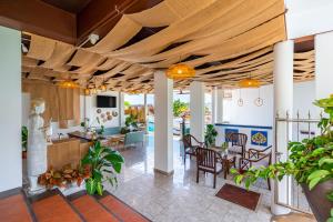 a living room with a wooden ceiling at Hotel Kata Hill Sea View in Kata Beach