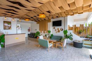 a living room with a table and chairs at Hotel Kata Hill Sea View in Kata Beach