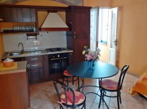 a kitchen with a table and chairs in a kitchen at appartamento luxury lavitabella in centro in La Spezia